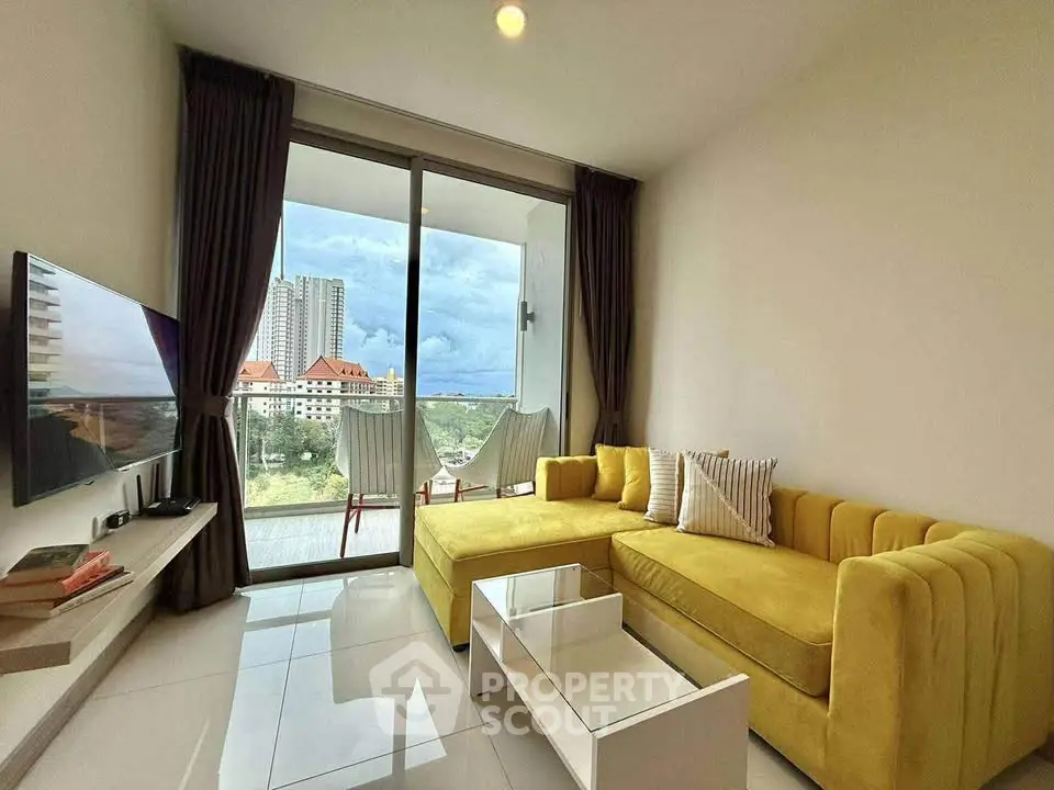 Modern living room with yellow sofa and balcony view in high-rise apartment.