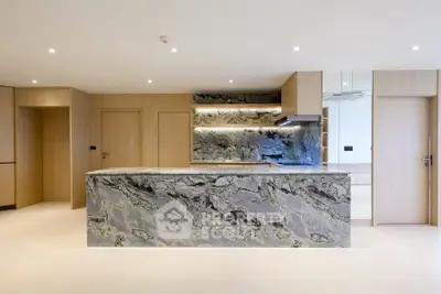 Luxurious modern kitchen with marble island and sleek wooden cabinetry