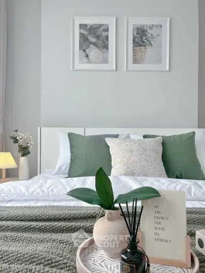 Elegant bedroom with stylish decor and cozy ambiance, featuring green accents and modern artwork.