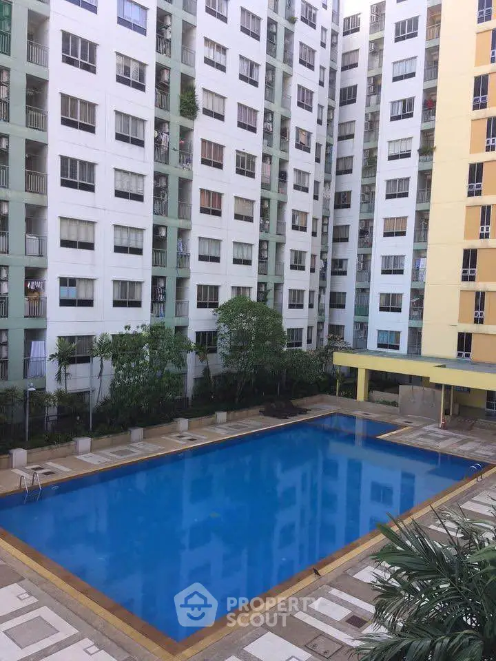 Spacious residential complex with a large swimming pool and modern high-rise buildings.
