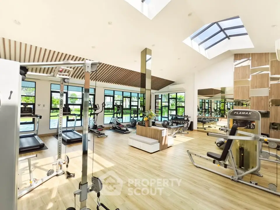 Spacious modern gym with natural light and state-of-the-art equipment