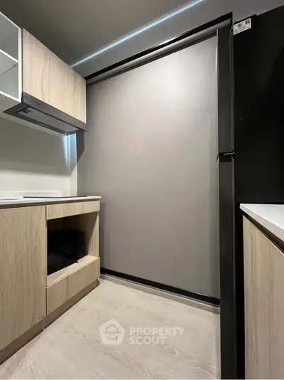 Modern kitchen with sleek cabinetry and built-in appliances in a compact layout.