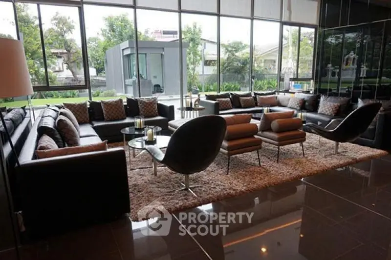 Luxurious modern living room with large windows and stylish furniture overlooking a lush garden.