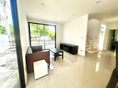 Bright modern living room with large windows and sleek furniture