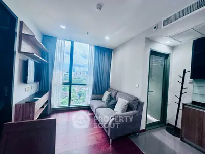 Modern living room with city view, stylish furniture, and large window for natural light.