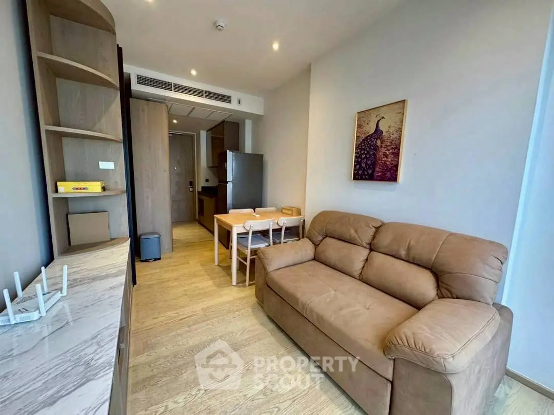 Modern living room with cozy sofa and dining area in stylish apartment.