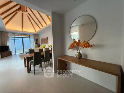 Spacious modern living room with vaulted ceiling and elegant dining area