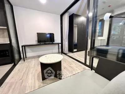 Modern living room with sleek furniture and large windows in a stylish apartment.