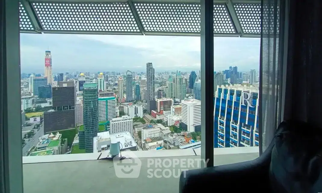 Stunning cityscape view from a high-rise apartment with floor-to-ceiling windows.