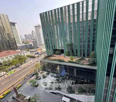 Stunning modern building with green facade and rooftop garden in urban setting.