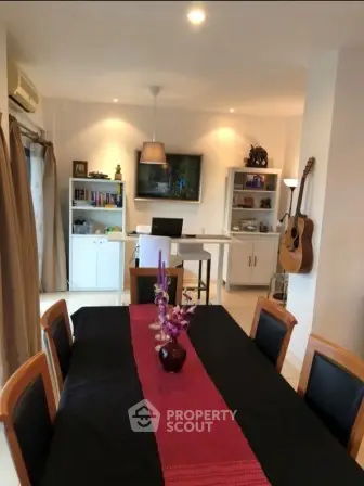 Charming dining area with elegant table setting and cozy decor in modern home.