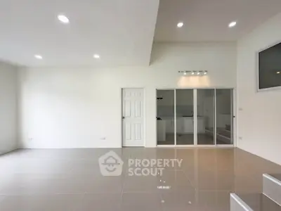 Spacious modern living room with high ceiling and sleek tile flooring