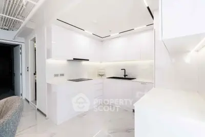 Sleek modern kitchen with white cabinetry and minimalist design