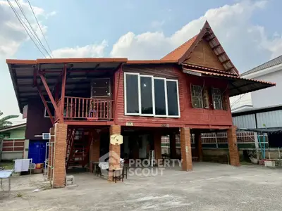 Charming elevated wooden house with spacious outdoor area and traditional architecture.