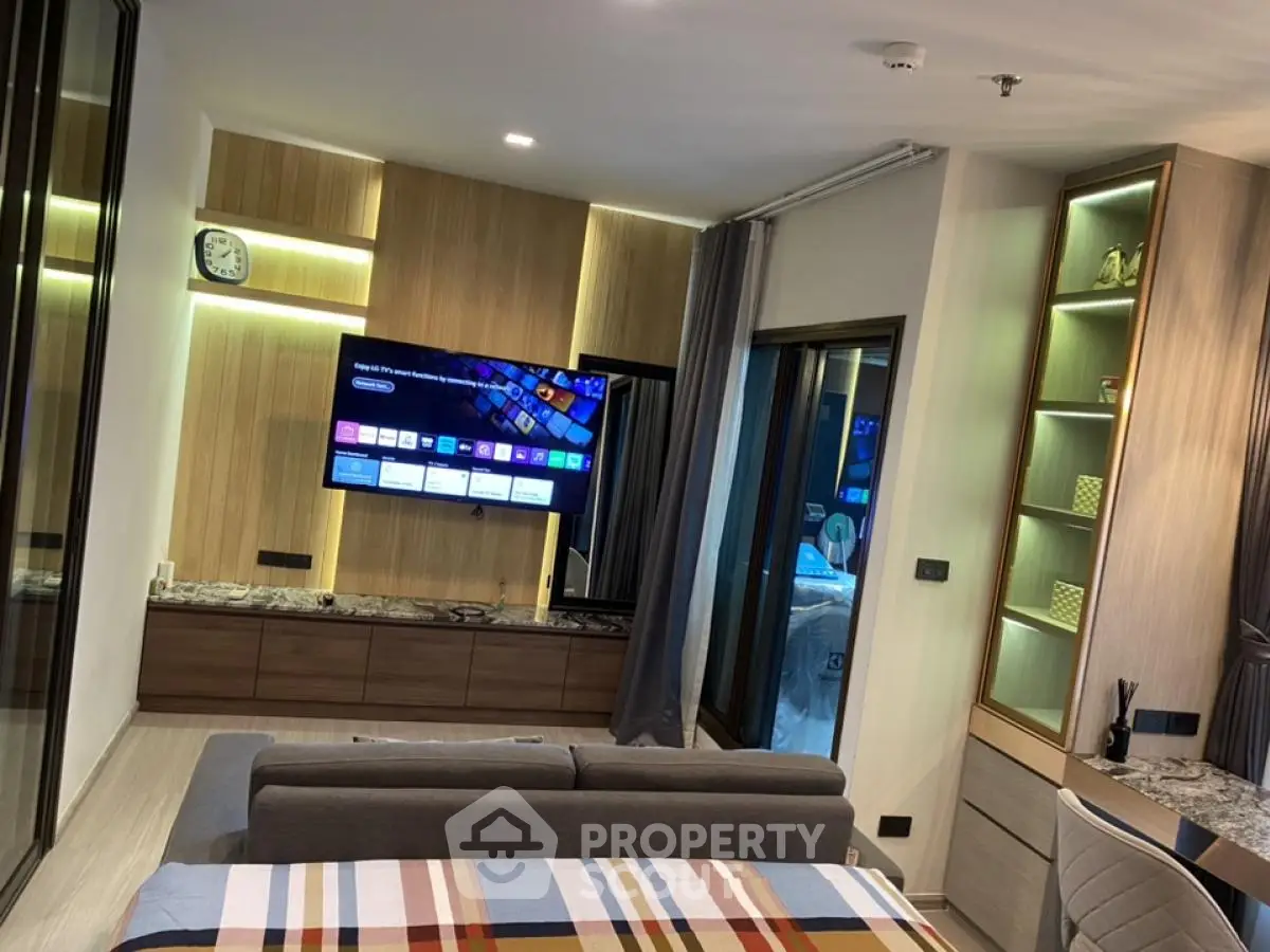 Modern living room with stylish decor and wall-mounted TV in contemporary apartment