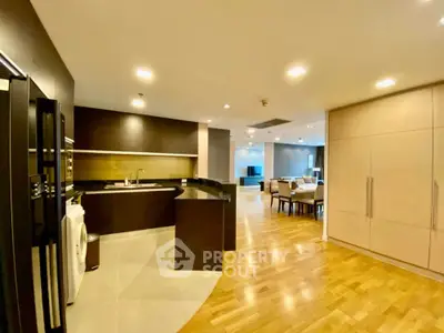 Spacious open-plan kitchen and living area with modern appliances and wooden flooring