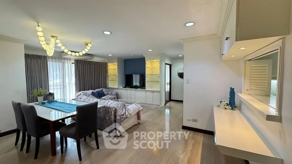 Spacious living room with elegant decor and modern lighting in a luxurious apartment.