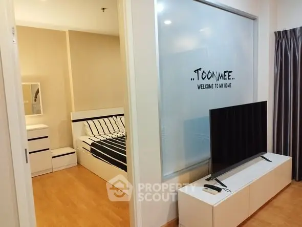 Modern bedroom with stylish decor and TV unit in cozy apartment