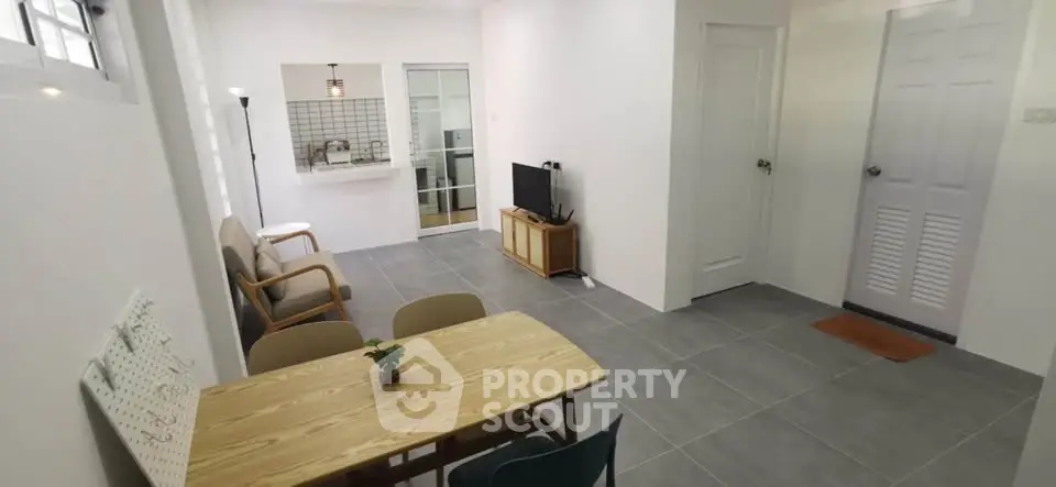 Spacious living room with modern decor and open kitchen view