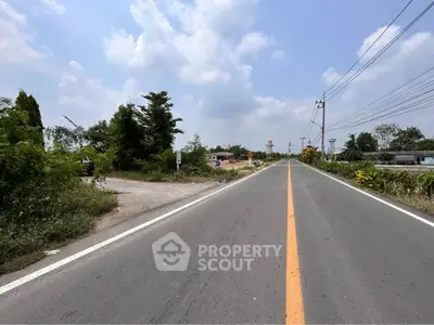Expansive road view with lush greenery, ideal for future real estate development.