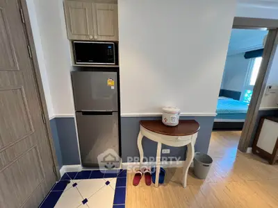 Charming kitchen corner with modern fridge and stylish table in cozy apartment.