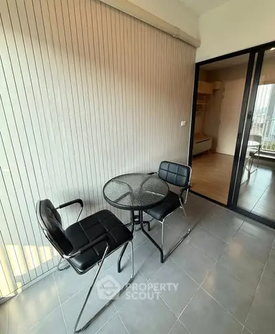 Modern balcony with sleek furniture and sliding glass doors