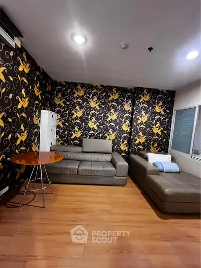 Stylish living room with modern furniture and vibrant wallpaper, perfect for cozy relaxation.