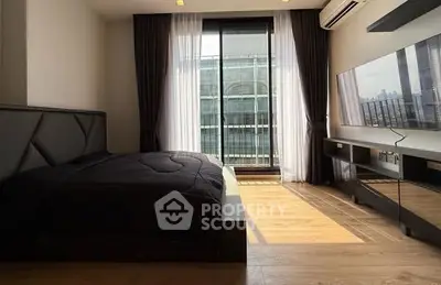 Modern bedroom with large window and sleek furnishings in urban apartment