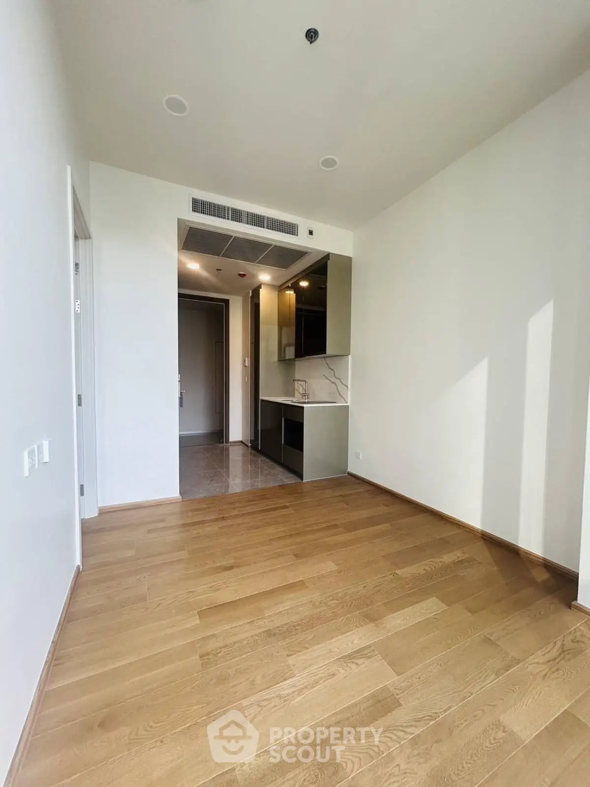 Modern apartment with sleek kitchen and hardwood floors, perfect for urban living.