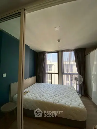 Modern bedroom with large windows and stylish decor in urban apartment