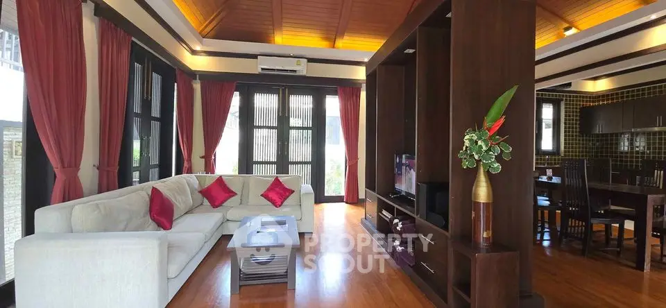 Spacious living room with elegant wooden accents and cozy seating area.