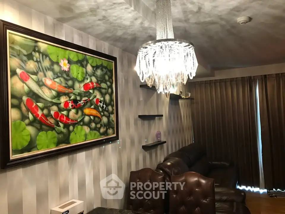 Luxurious living room with elegant chandelier and koi fish artwork, perfect for sophisticated urban living.
