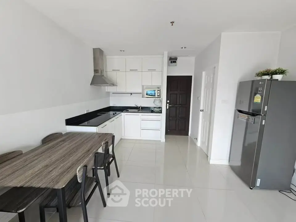 Modern kitchen with sleek design and dining area in a bright apartment