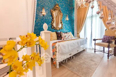 Luxurious bedroom with elegant decor, ornate mirror, and vibrant accents for a sophisticated living experience.
