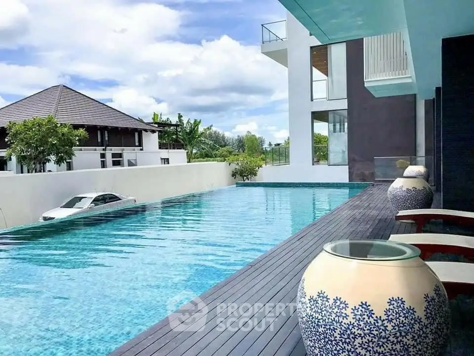 Luxurious modern poolside view with elegant decor and serene ambiance.