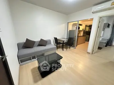 Modern living room with sleek furniture and open kitchen layout