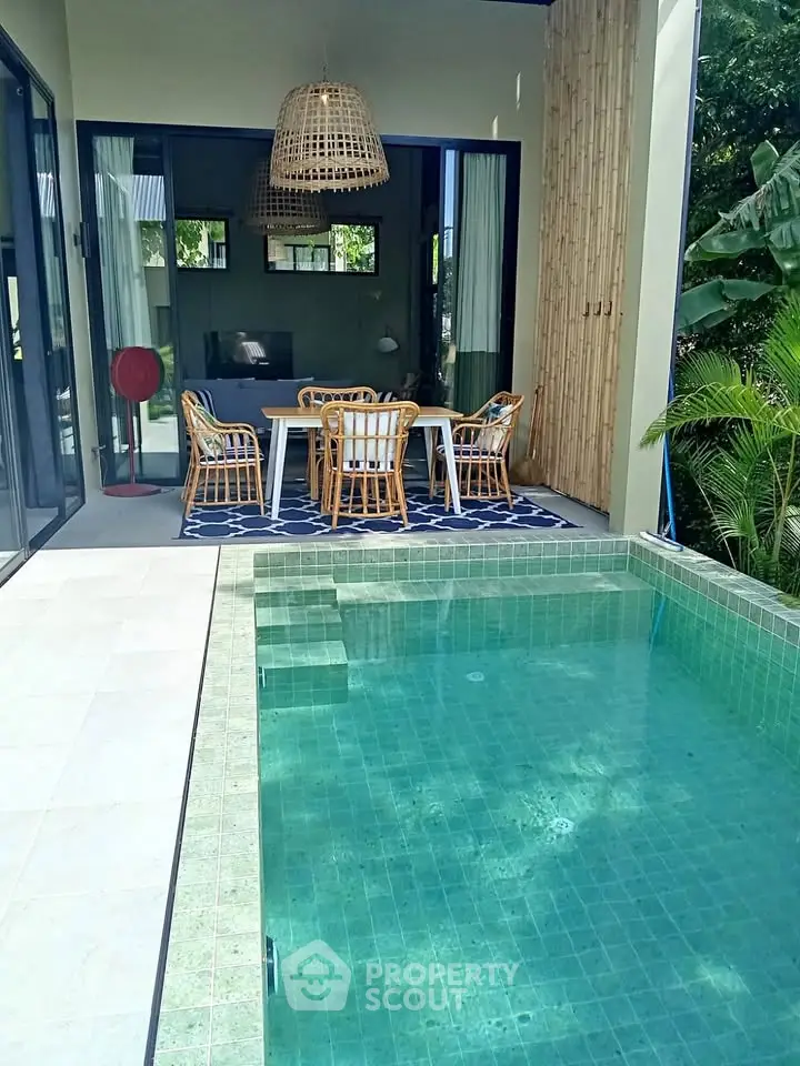 Luxurious villa with private pool and stylish outdoor dining area, perfect for relaxation and entertaining.