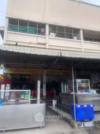 Commercial property with food stalls and seating area, ideal for business opportunities.