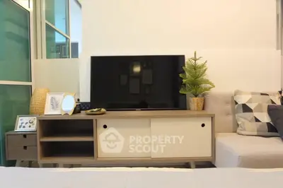 Modern living room with sleek TV stand and cozy decor