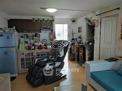 Cozy living room with massage chair and open kitchen layout