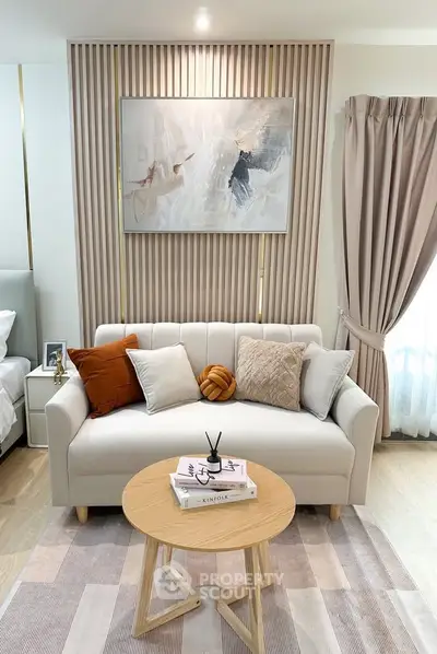 Elegant living room with modern decor, featuring a cozy sofa, stylish coffee table, and chic wall art.