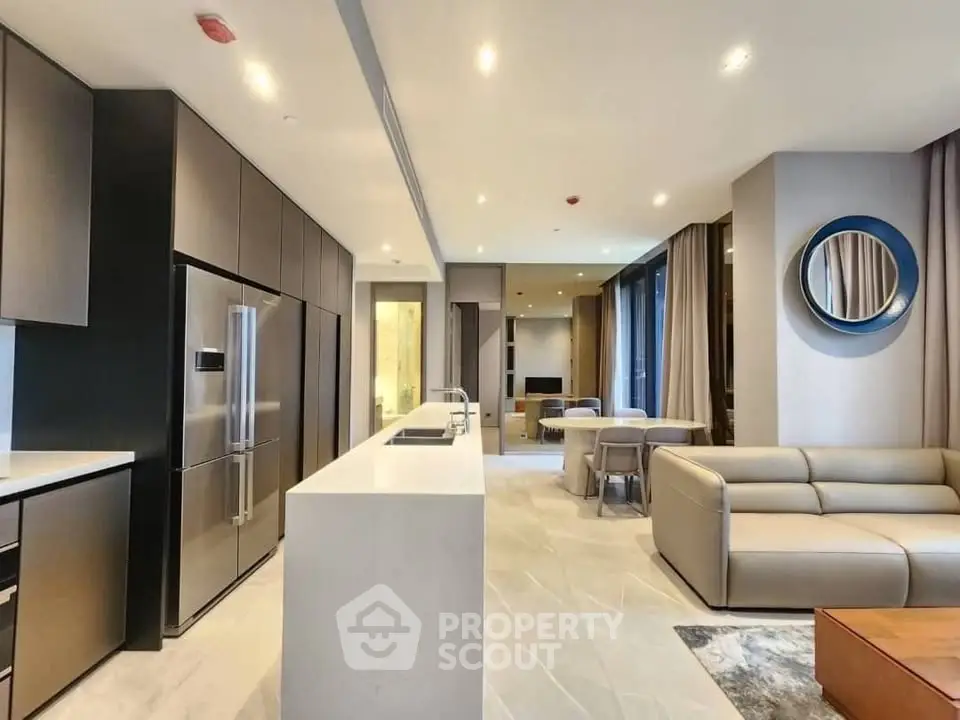 Luxurious modern living room with open kitchen, sleek furniture, and elegant lighting in a high-end apartment.
