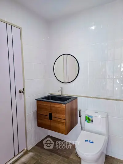 Modern bathroom with sleek fixtures and stylish wooden vanity