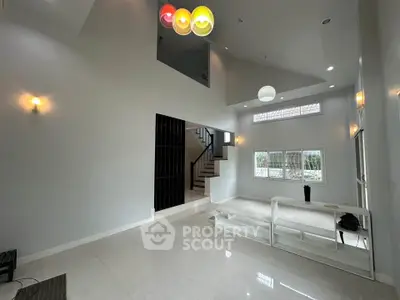 Spacious modern living room with high ceilings and elegant lighting