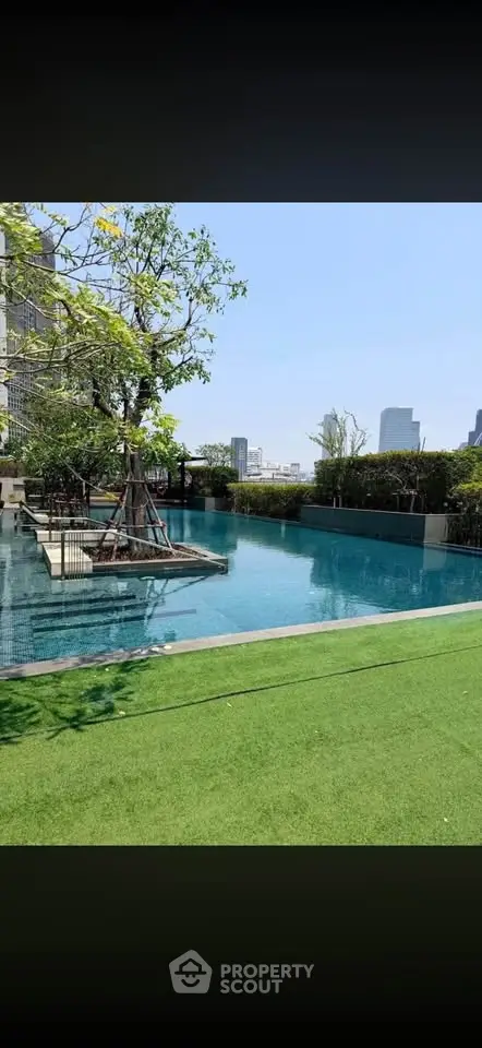 Luxurious rooftop pool with stunning city views and lush greenery, perfect for relaxation and leisure.