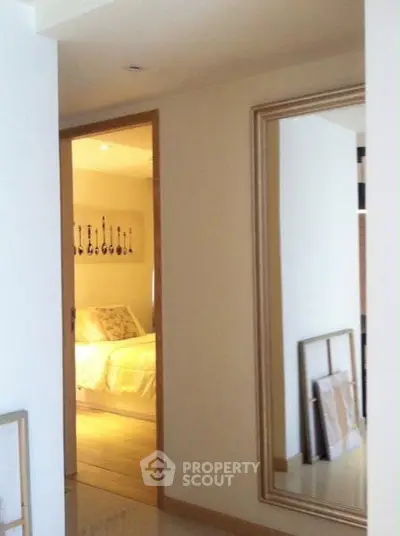 Elegant bedroom entrance with large mirror and cozy decor