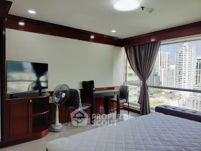Spacious bedroom with city view, modern furniture, and large window for natural light.