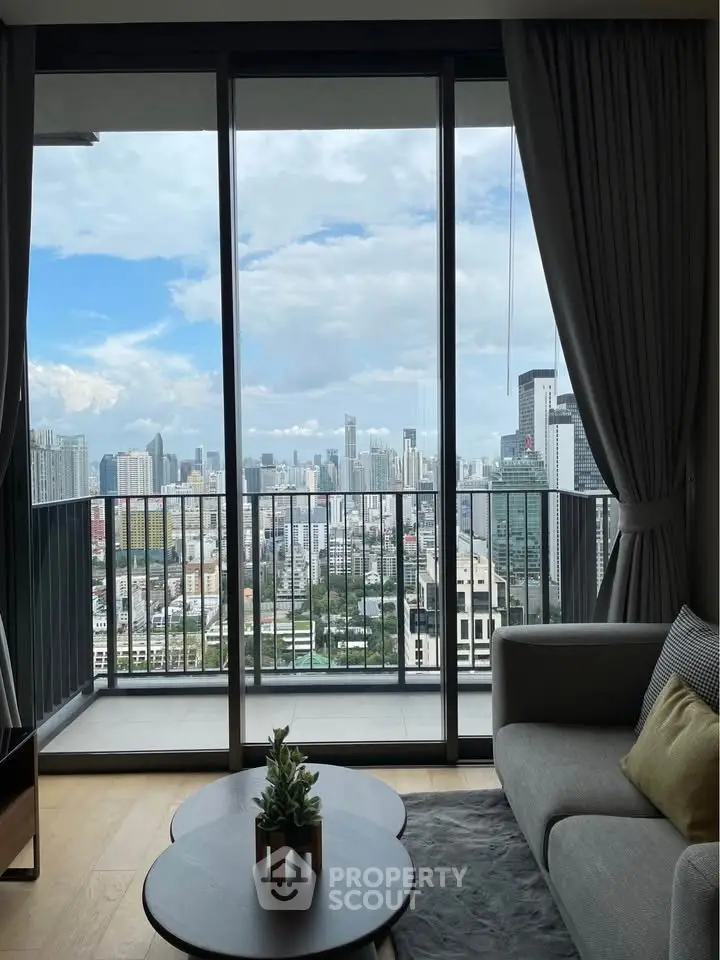 Stunning city view from modern living room with floor-to-ceiling windows and cozy decor.