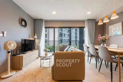 Modern living room with stylish decor and balcony view in a contemporary apartment.