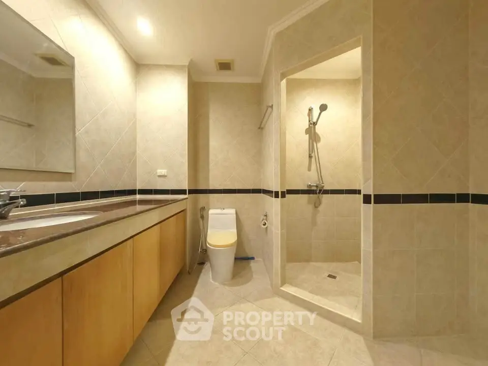 Spacious bathroom with modern fixtures and elegant tile design